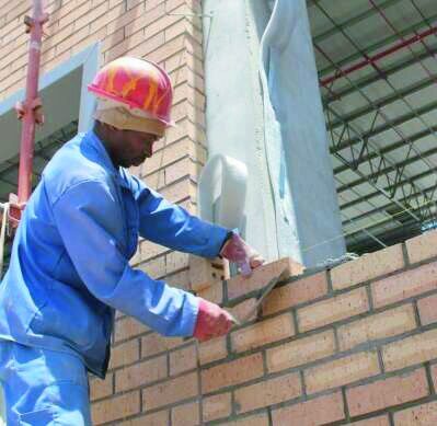 Boliville bricklayer laying facing brick
